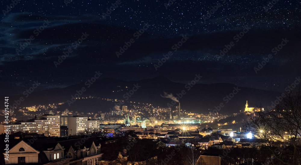 Fototapeta premium Industrial city in night with sky full of stars