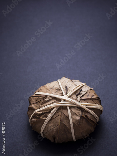 French banon cheese wrapped in chestnut leaves isolated on black background photo
