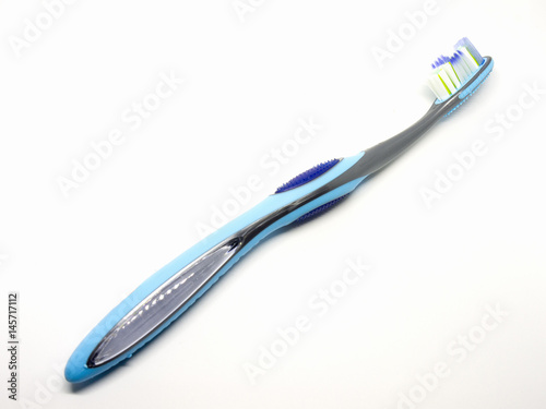 Blue plastic toothbrush on a white background.