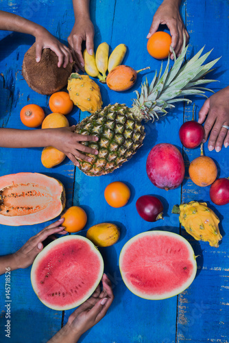 colorful tropical fruits on blue wooden background.exotic fruits arrangement