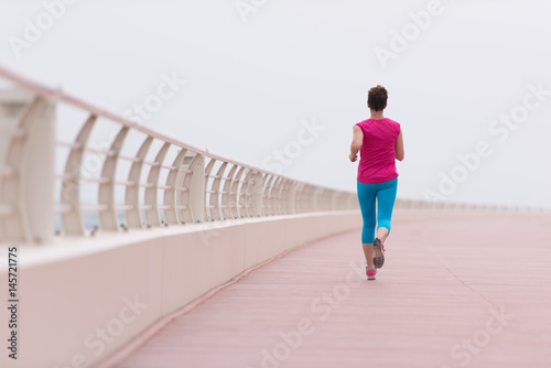 woman busy running on the promenade