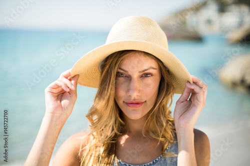 Beautiful young woman wearing sun hat