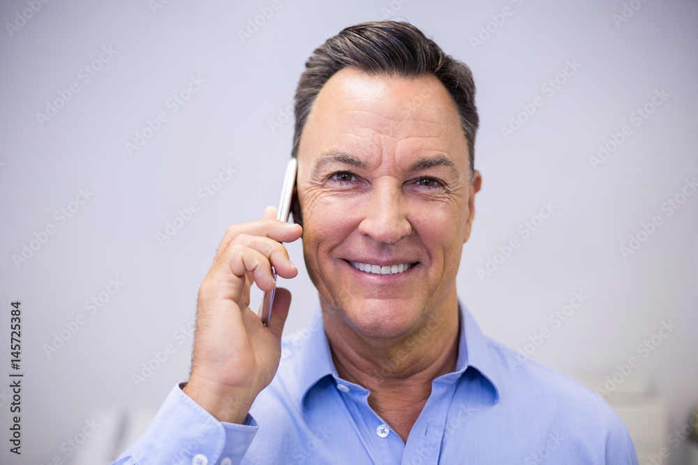 Dentist talking on mobile phone Dentist talking on mobile phone
