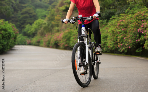 cyclist cycling mountain bike on foggy forest trail © lzf