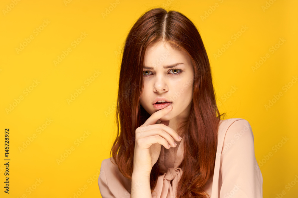 red-haired woman on a yellow background, emotions, reverie red-haired woman on a yellow background, emotions, reverie