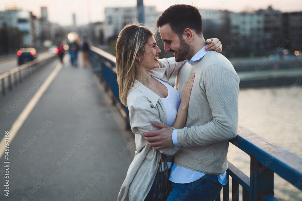 Happy romantic couple hugging and smiling - obrazy, fototapety, plakaty 