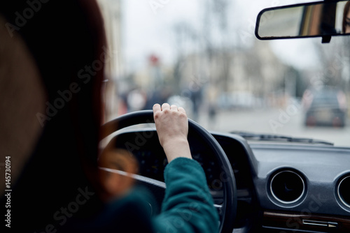 a woman is driving a car