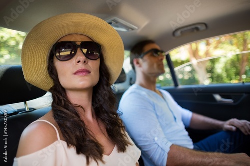 Couple wearing sunglasses traveling in car © wavebreak3