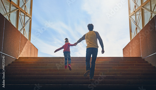 Bild auf Leinwand Father and child climb upstairs.