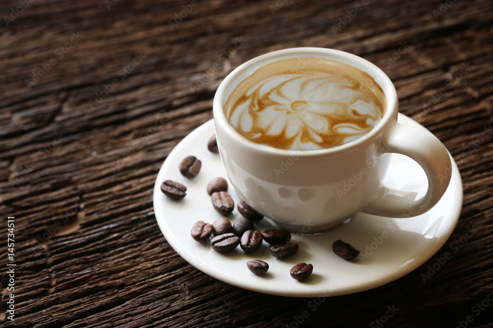 Cup of coffee latte on the old wood table vintage. Cup of coffee latte on the old wood table vintage.