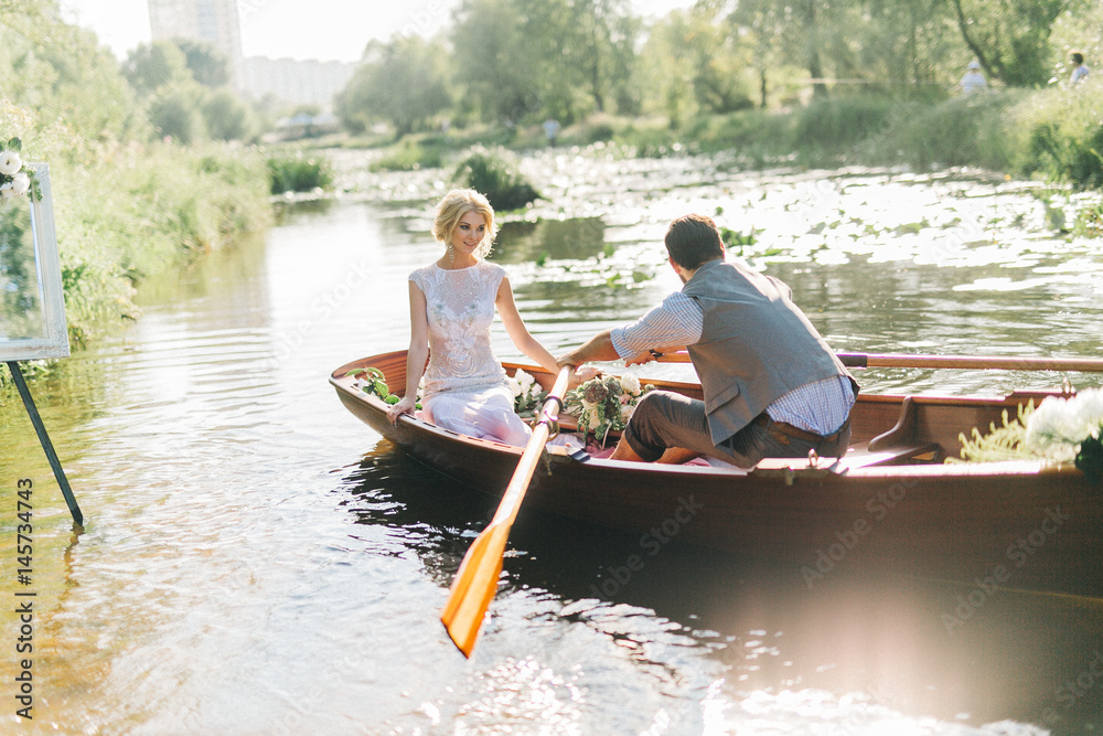 Young wedding couple posing on the boat Young wedding couple posing on the boat
