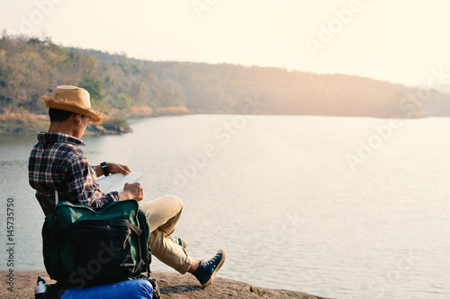 Happy Asian hipster man backpack in nature background, Relax time on holiday concept travel , color of vintage tone and soft focus
