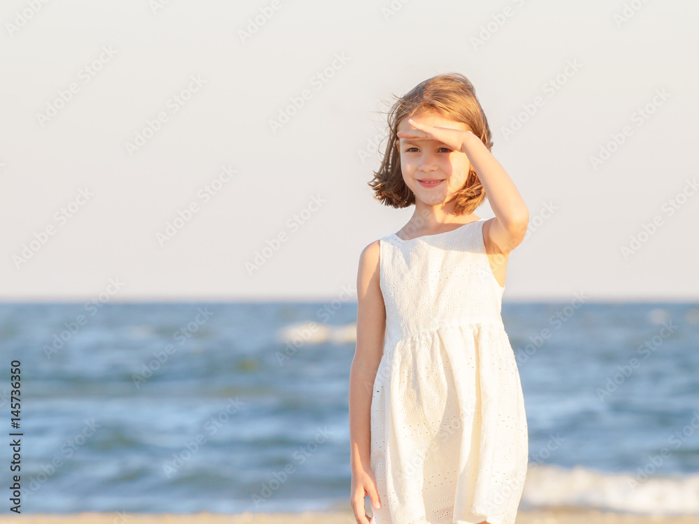 Cute little girl with white dress in front of the Black Sea, at Sulina, Romania Cute little girl with white dress in front of the Black Sea, at Sulina, Romania