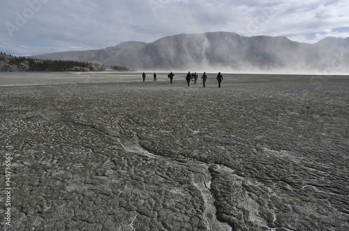 group of people in front of a dust storm at dry territory photo