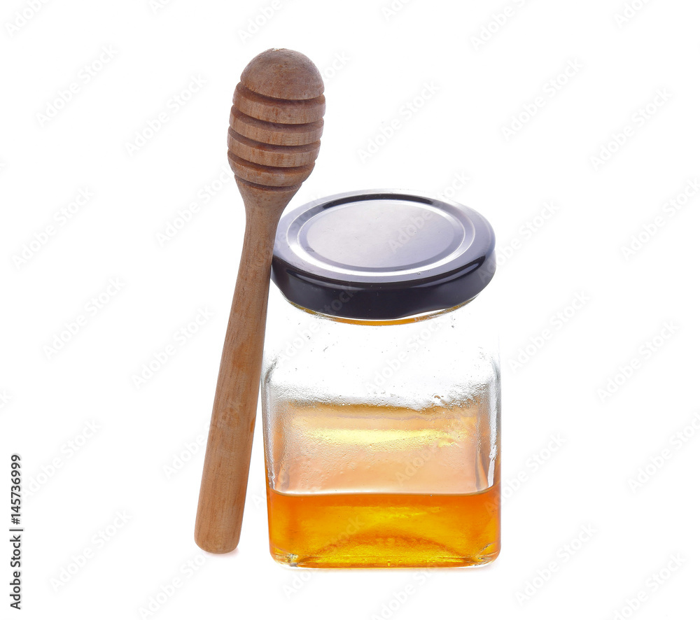 honey with wooden honey dipper on jar on white background honey with wooden honey dipper on jar on white background