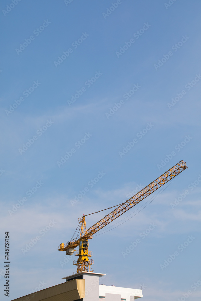Abstract Industrial background with construction cranes silhouettes over amazing sunset sky Abstract Industrial background with construction cranes silhouettes over amazing sunset sky