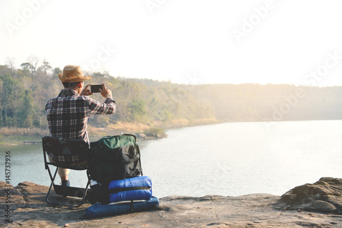 Wallpaper Mural Happy Asian hipster man backpack in nature background, Relax time on holiday concept travel , color of vintage tone and soft focus Torontodigital.ca