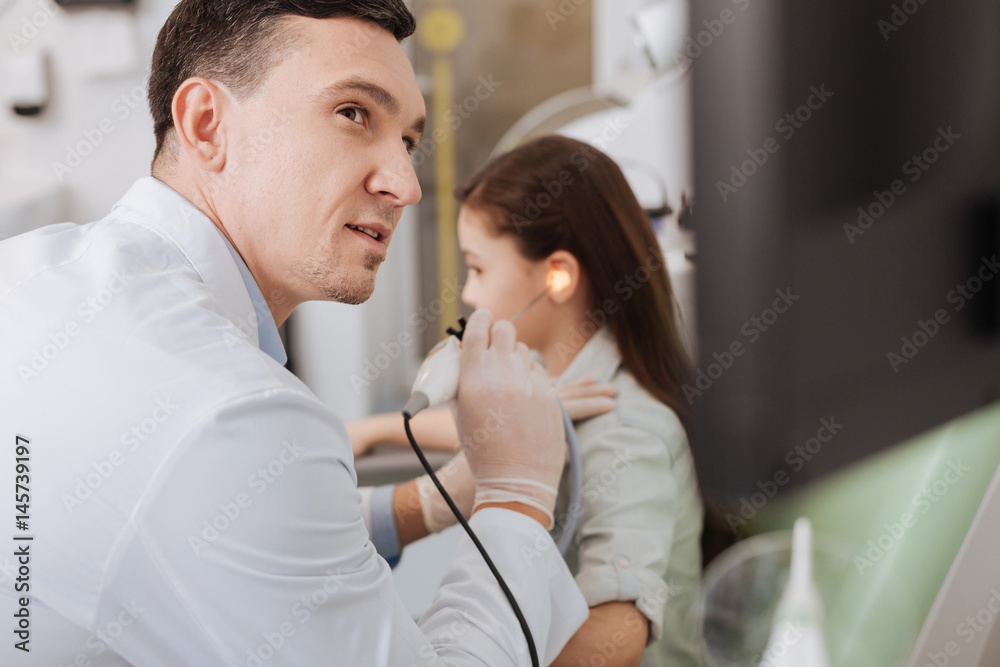 Fototapeta premium Competent otolaryngologist doing hearing exam