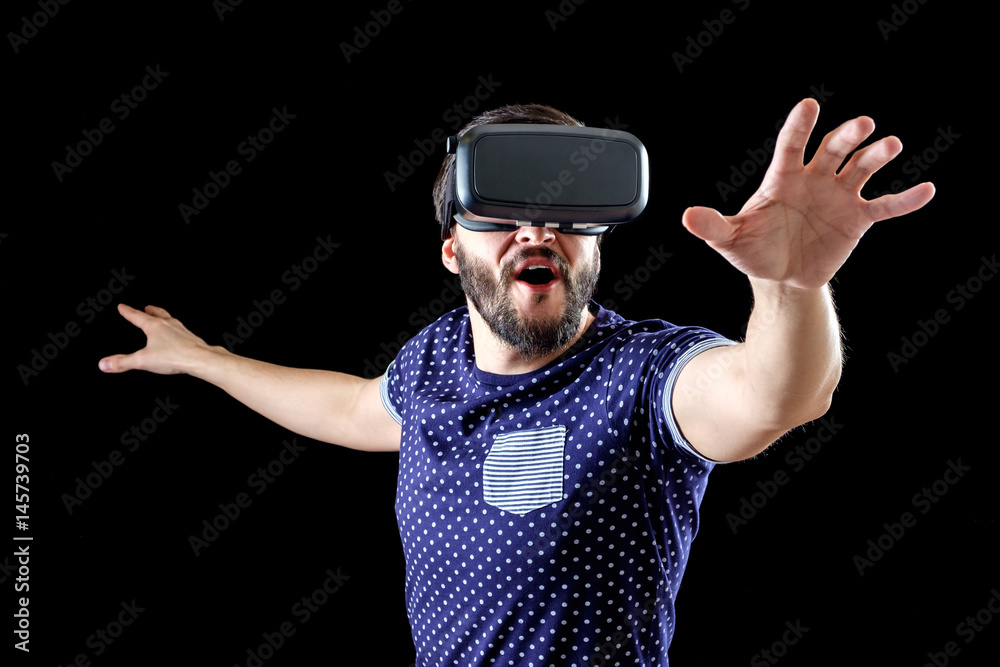 Man in blue dotted T-shirt wearing virtual reality 3d-headset Man in blue dotted T-shirt wearing virtual reality 3d-headset