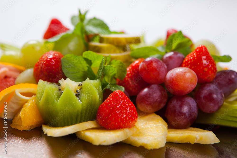 Mixed Fruit platter with assorted fruits on a white background Mixed Fruit platter with assorted fruits on a white background