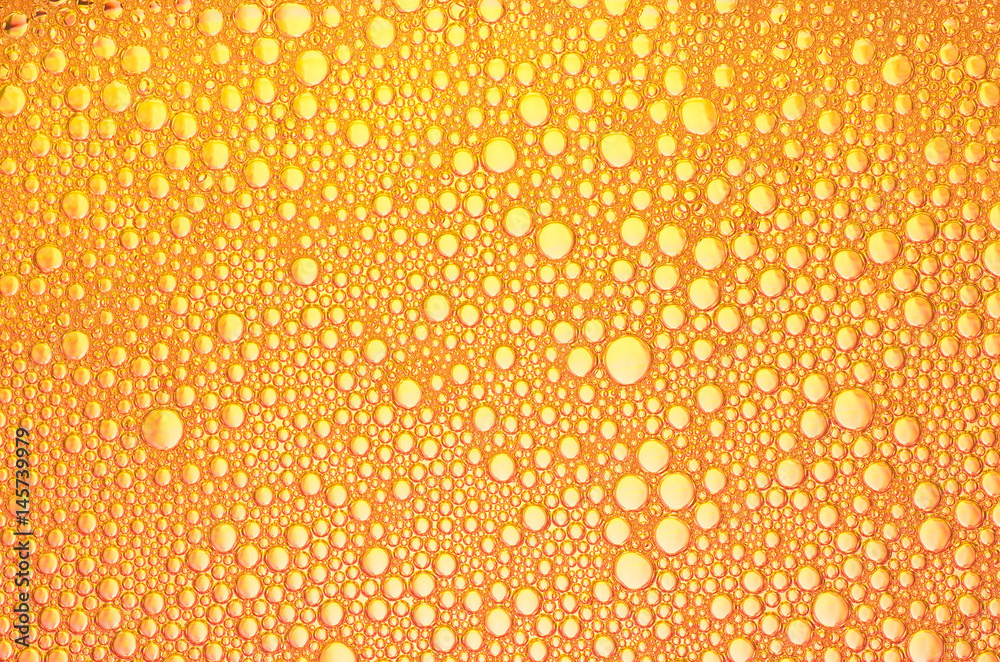 the orange bubbles on the surface of the liquid