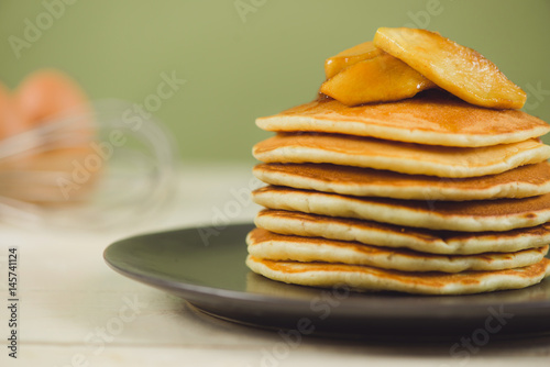 Pancakes with apple on table. Breakfast, snacks. Pancakes Day.