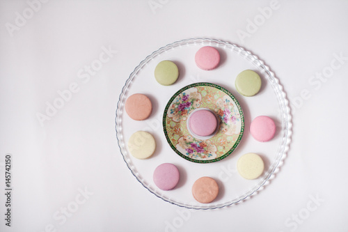 Macaroons in the glass plate on the white background