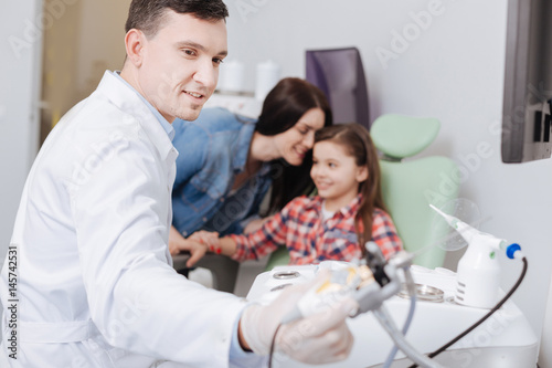 Attentive positive doctor taking ENT instrument