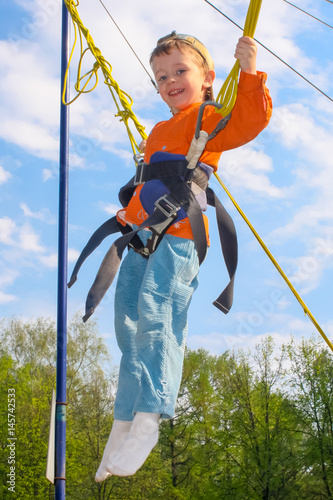 Fotografie child on a trampoline