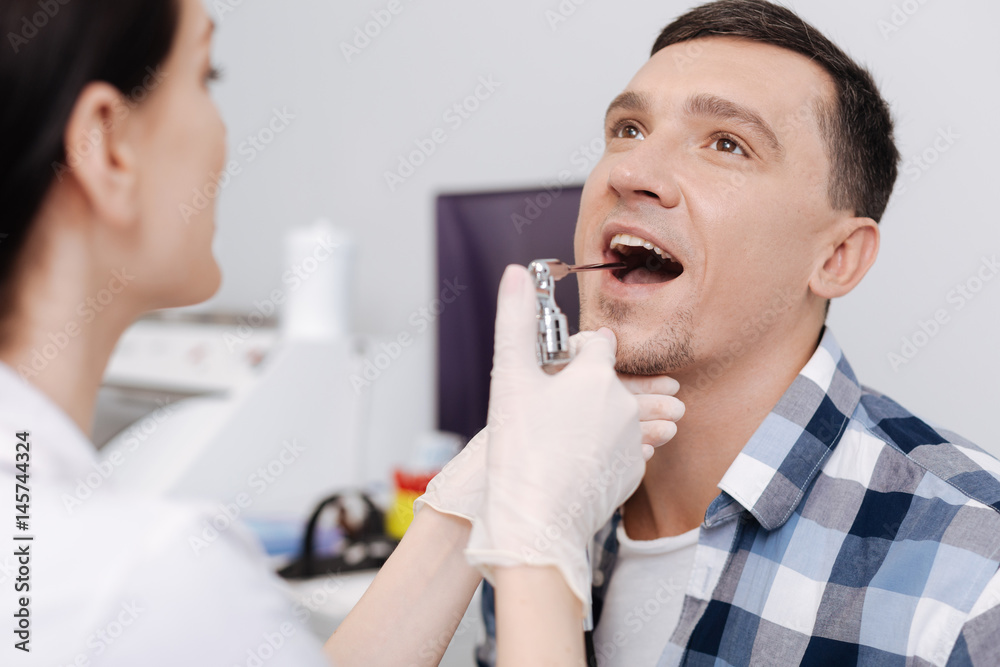 Close up of male patient sitting with opened mouth Close up of male patient sitting with opened mouth