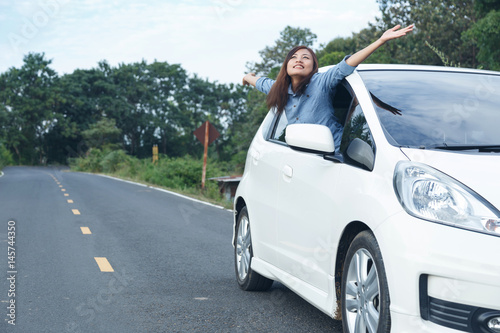 Beautiful girl traveling with her car