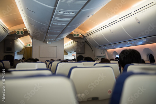 Passengers sit in flight during travel abroad in airplane.