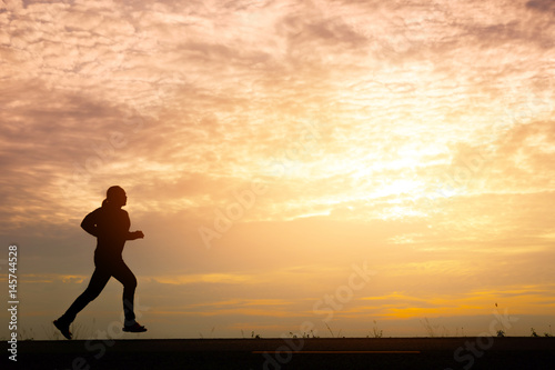 Fototapeta Naklejka Na Ścianę i Meble -  Silhouette man relaxing by running