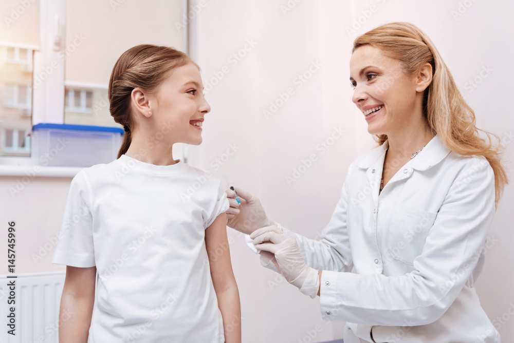 Positive delighted patient and nurse looking at each other Positive delighted patient and nurse looking at each other