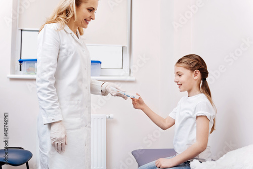 Smiling doctor standing opposite her patient © Viacheslav Yakobchuk