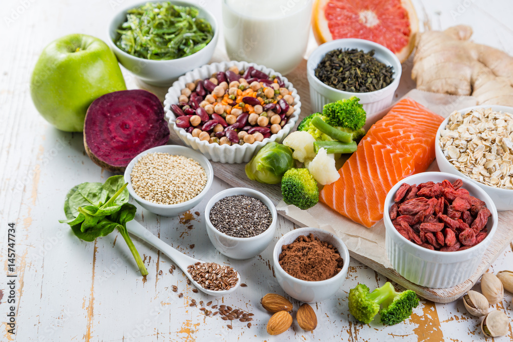 Selection of superfoods on rustic background