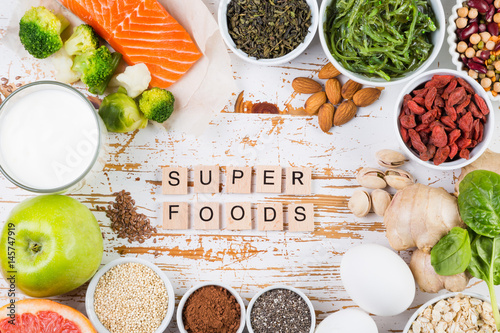 Selection of superfoods on rustic background