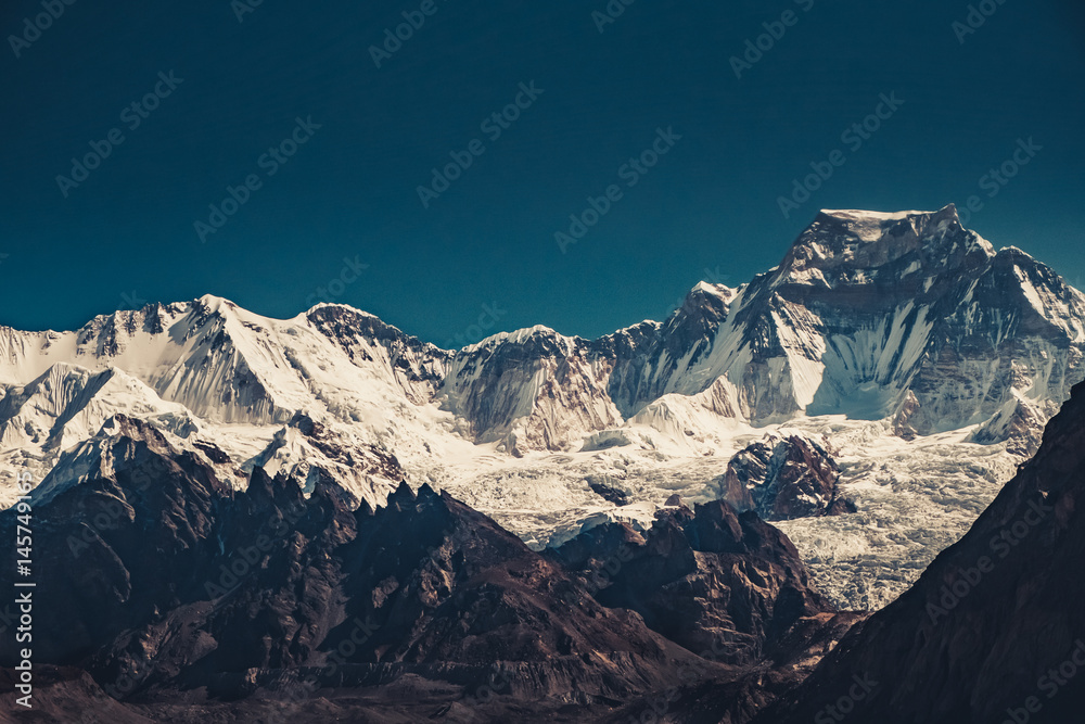 Beautiful mountain range in sunrise light. Dramatic and majestic nature landscape. Trekking in Nepal to Everest Base Camp, Himalaya. Vintage toning effect. Exploring beauty world. Natural background