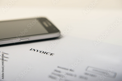 Invoice and mobile phone for concept of mobile payment