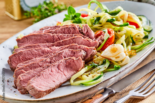 Fotografie Tender medium rare roast beef with salad