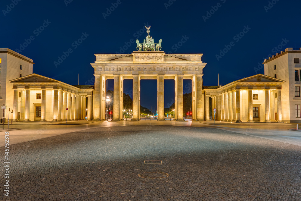 The famous Brandenburg Gate in Berlin illuminated at darkness