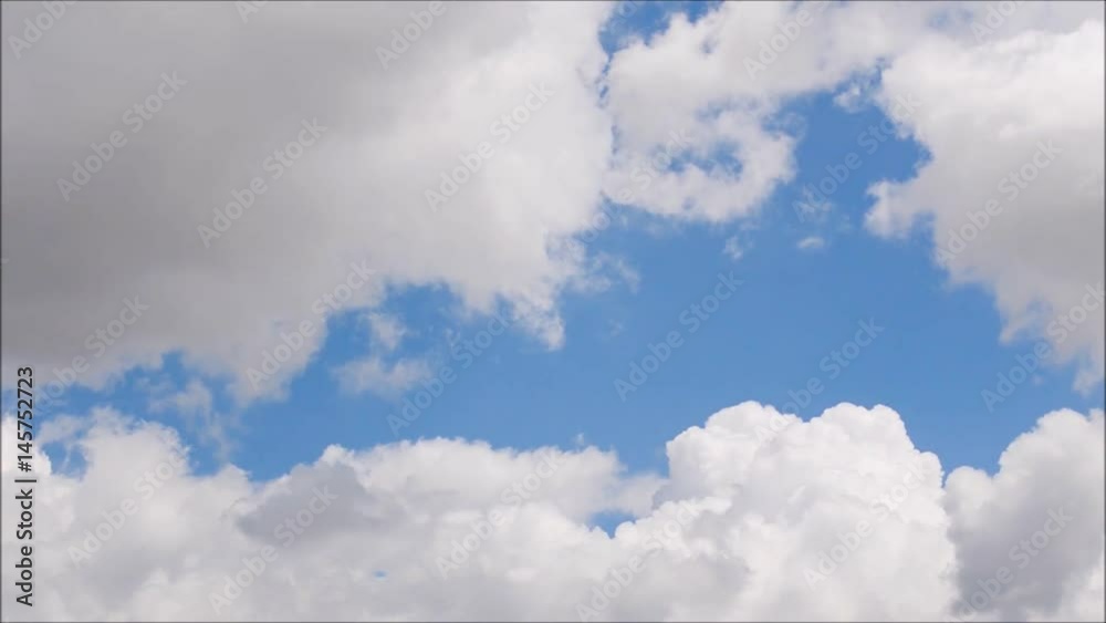 White clouds move across clear blue sky. Cloudy blue sky background. White clouds move across clear blue sky. Cloudy blue sky background.