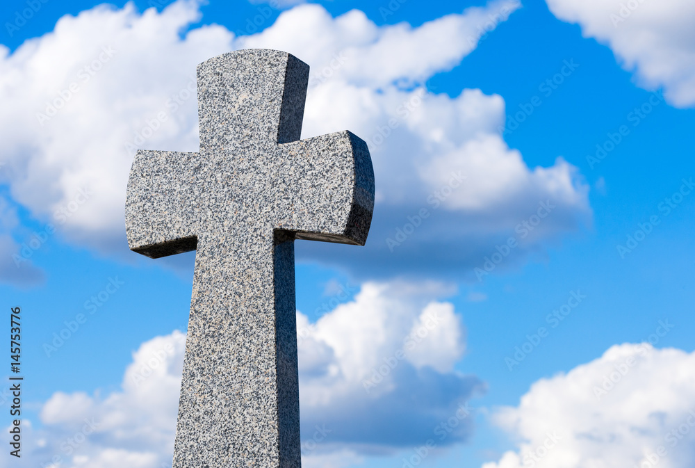Granite cross the background of clouds and sky