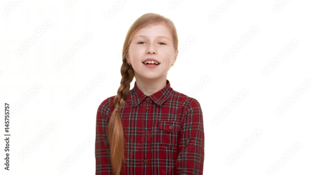 Young confident Caucasian teenager girl standing on white background with folded hands and smiling looking at camera Young confident Caucasian teenager girl standing on white background with folded hands and smiling looking at camera