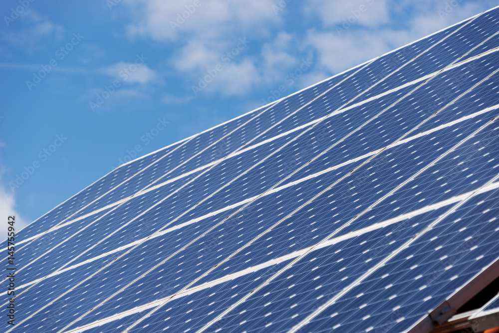 Alternative energy photovoltaic solar panels on roof of residential house Alternative energy photovoltaic solar panels on roof of residential house