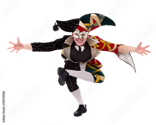 harlequin wearing a mask, isolated on white background in full length. photo