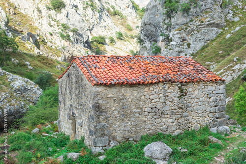 The Canal del Texu is a hiking trail and a passage way between the village Bulnes and Poncebos at the river Rio Cares. The trackway leads along the river Rio Bulnes, at the foot of the Picos de Europa photo