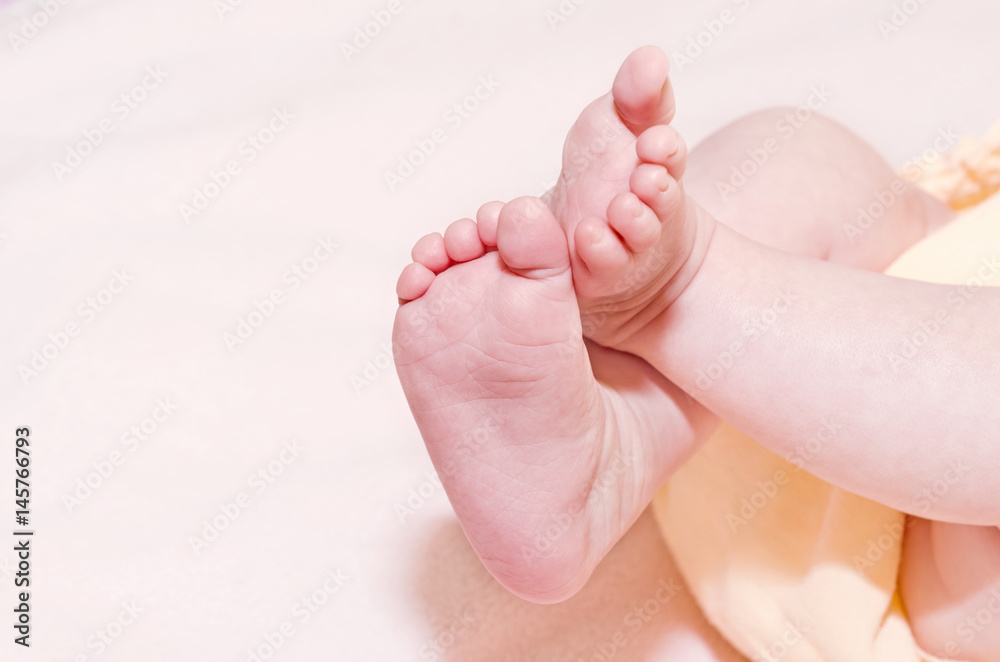 Little legs newborn on a blanket. Selective focus, space for text. Little legs newborn on a blanket. Selective focus, space for text.