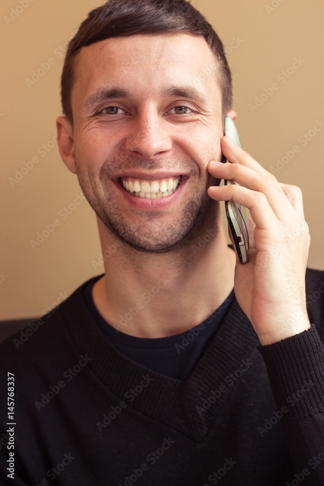 Portrait of a young man. The young man said by telephone. A young man sits in the Office. Portrait of a young man. The young man said by telephone. A young man sits in the Office.