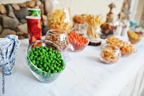 Table catering with peanuts and snacks at wedding reception.